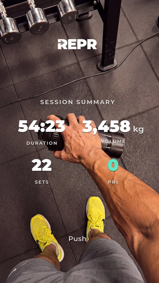 A REPR session summary over a first-person photo holding a dumbbell: 54:23 duration, 3,458 kg volume, 22 sets, Push session